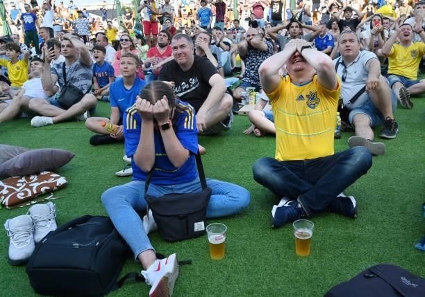 Ukrainian supporters react as they watch the UEFA EURO 2020 Group C football match between the Ukraine and North Macedonia on a giant screen of the...
