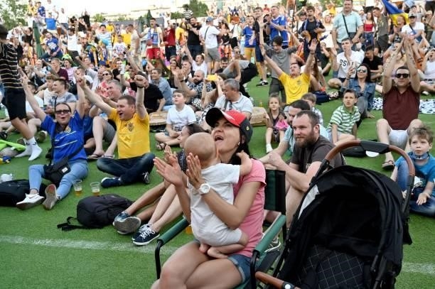 Ukrainian supporters react as they watch the UEFA EURO 2020 Group C football match between the Ukraine and North Macedonia on a giant screen of the...