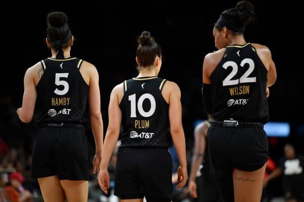 Dearica Hamby of the Las Vegas Aces, Kelsey Plum of the Las Vegas Aces and A'ja Wilson of the Las Vegas Aces looks on during the game against the New...