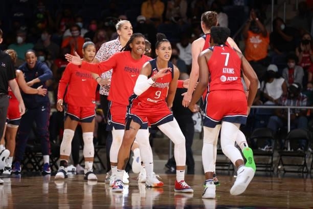 Natasha Cloud and Ariel Atkins of the Washington Mystics high five during the game against the Atlanta Dream on June 17, 2021 at Entertainment &...