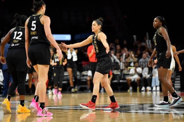 Kelsey Plum of the Las Vegas Aces high fives Dearica Hamby of the Las Vegas Aces and Chelsea Gray of the Las Vegas Aces during the game against the...