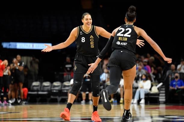 Liz Cambage of the Las Vegas Aces high fives A'ja Wilson of the Las Vegas Aces during the game against the New York Liberty on June 17, 2021 at...