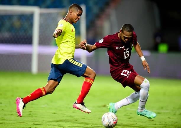 Jose Martinez of Venezuela competes for the ball with Wilmar Barrios of Colombia during the match between Colombia and Venezuela as part of Conmebol...