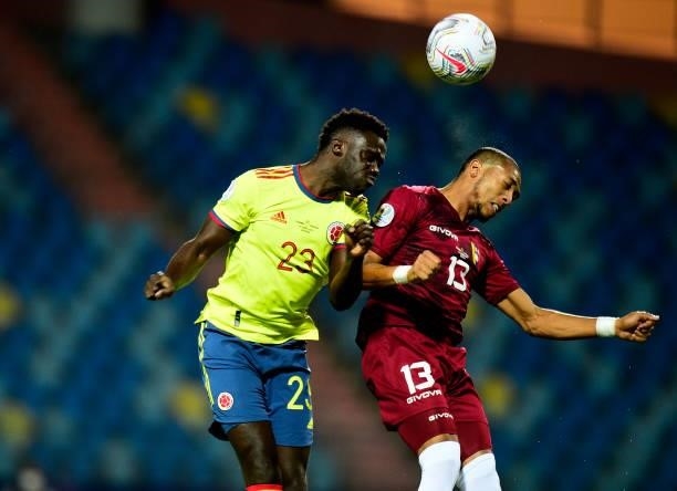 Davinson Sanchez of Colombia heads the ball over Jose Martinez of Venezuela ,during the match between Colombia and Venezuela as part of Conmebol Copa...