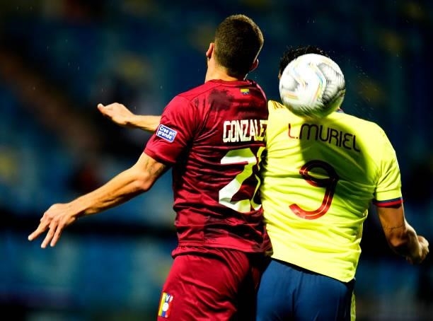 Luis Muriel of Colombia heads the ball against Alexander Gonzalez of Venezuela ,during the match between Colombia and Venezuela as part of Conmebol...