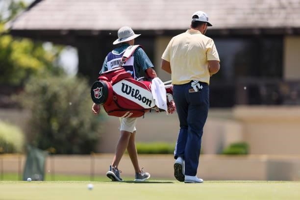 Quade Cummins and his caddie walk to the clubhouse after the first round of the Wichita Open Benefitting KU Wichita Pediatrics at Crestview Country...