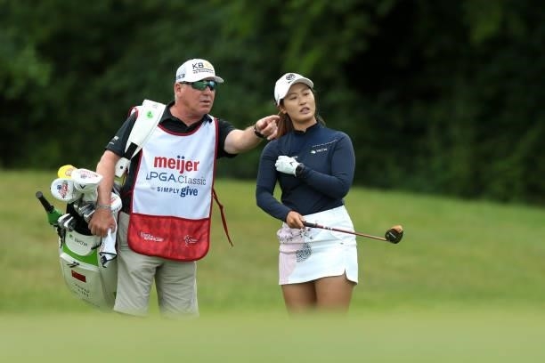 Xiyu Lin of China talks to her caddie on the 10th hole during the first round of the Meijer LPGA Classic for Simply Give golf tournament at...