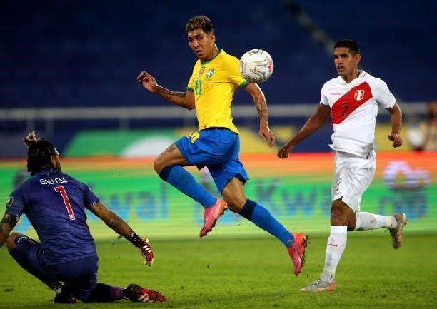 Roberto Firmino of Brazil competes for the ball with Luis Abram and Pedro Gallese of Peru during the match between Brazil and Peru as part of...