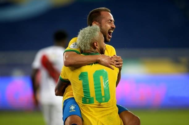 Everton Ribeiro of Brazil celebrates after scoring a goal with his team mate Neymar during the match between Brazil and Peru as part of the Conmebol...