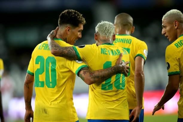 Neymar of Brazil celebrates with his team mate Roberto Firmino during the match between Brazil and Peru as part of Conmebol Copa America Brazil 2021...