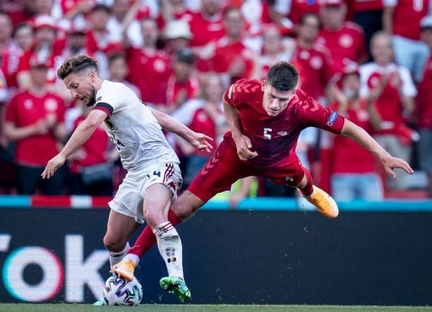 Denmark's defender Joakim Maehle goes down in a challenge with Belgium's forward Dries Mertens during the UEFA EURO 2020 Group B football match...