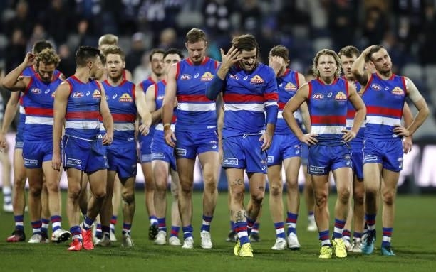 Western Bulldogs players leave the field after a loss during the 2021 AFL Round 14 match between the Geelong Cats and the Western Bulldogs at GMHBA...
