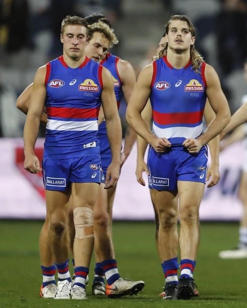 Bailey Smith of the Bulldogs and Roarke Smith of the Bulldogs look dejected after a loss during the 2021 AFL Round 14 match between the Geelong Cats...