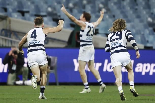 Shaun Higgins of the Cats and Cameron Guthrie of the Cats celebrate in the foreground as Gary Rohan of the Cats celebrates after kicking a goal to...