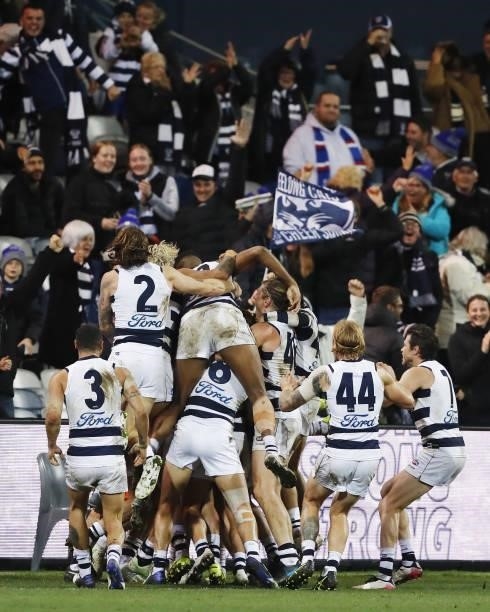 Gary Rohan of the Cats celebrates with teammates after kicking a goal to win the match after the siren during the 2021 AFL Round 14 match between the...
