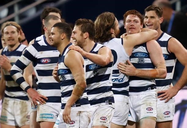 Cats players celebrate after Gary Rohan of the Cats kicked a goal after the siren to win the match during the 2021 AFL Round 14 match between the...