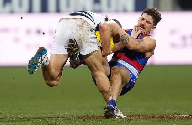 Joel Selwood of the Cats is tackled by Tom Liberatore of the Bulldogs during the 2021 AFL Round 14 match between the Geelong Cats and the Western...