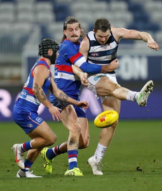 Patrick Dangerfield of the Cats is tackled by Josh Bruce of the Bulldogs during the 2021 AFL Round 14 match between the Geelong Cats and the Western...