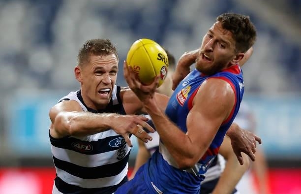 Marcus Bontempelli of the Bulldogs and Joel Selwood of the Cats in action during the 2021 AFL Round 14 match between the Geelong Cats and the Western...