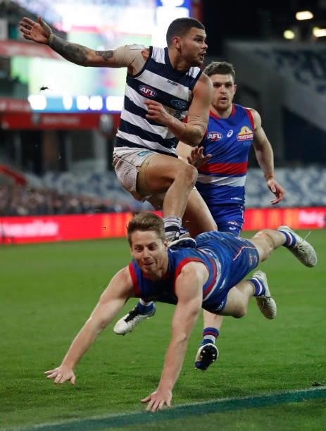 Brandan Parfitt of the Cats and Lachie Hunter of the Bulldogs in action during the 2021 AFL Round 14 match between the Geelong Cats and the Western...