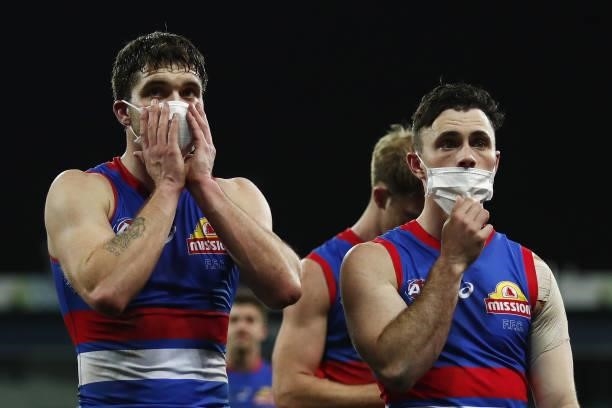 Bailey Williams of the Bulldogs and Toby McLean of the Bulldogs leave the field after a loss during the 2021 AFL Round 14 match between the Geelong...