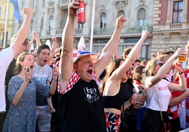 Supporters celebrate as they watch a broadcast of the UEFA EURO 2020 football match between Croatia and Czech Republic at the Jelacic square in...