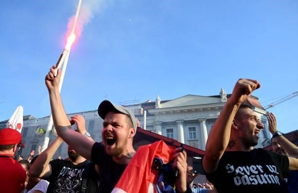 Supporters light flares as they watch a broadcast of the UEFA EURO 2020 football match between Croatia and Czech Republic at the Jelacic square in...