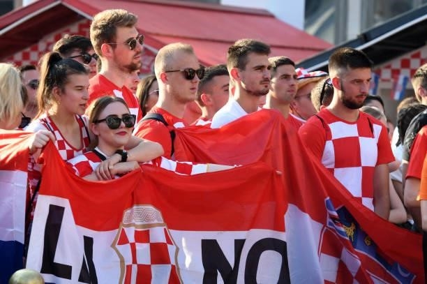 Supporters hold flags as they watch a broadcast of the UEFA EURO 2020 football match between Croatia and Czech Republic at the Jelacic square in...