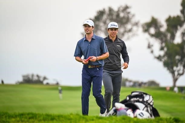 Amateur Cole Hammer smiles with Garrick Higgo of South Africa after they both carded birdies on the sixth hole green during the first round of the...