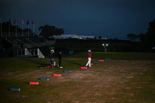 Bryson DeChambeau hits balls at night on the practice range after play following the first round of the 121st U.S. Open on the South Course at Torrey...