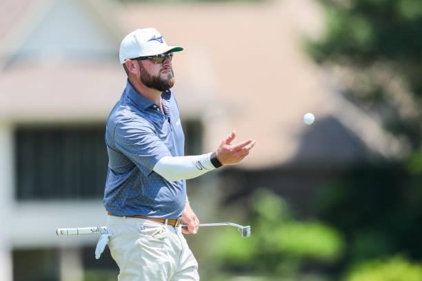Erik Barnes tosses a golf ball on the 18th hole during the second round of the Wichita Open Benefitting KU Wichita Pediatrics at Crestview Country...