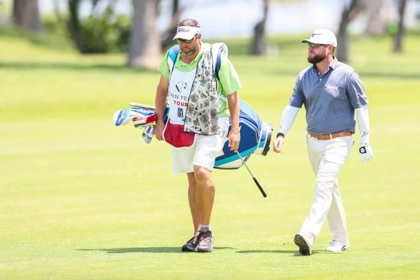 Erik Barnes walks with his caddie on the 18th hole during the second round of the Wichita Open Benefitting KU Wichita Pediatrics at Crestview Country...