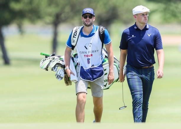 Harry Hall walks with his caddie on the 18th hole during the second round of the Wichita Open Benefitting KU Wichita Pediatrics at Crestview Country...
