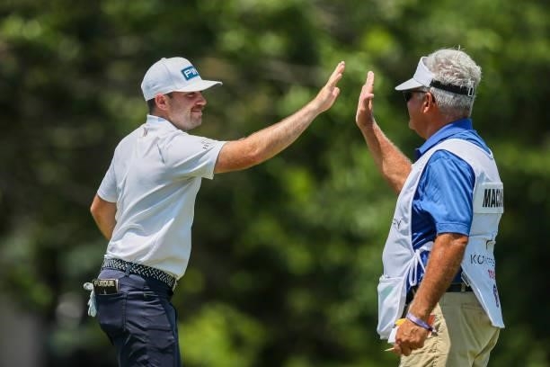 Stuart Macdonald reacts with his caddie after sinking his putt on the 18th hole during the second round of the Wichita Open Benefitting KU Wichita...
