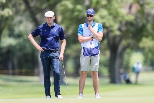 Harry Hall looks on with his caddie from the 18th green during the second round of the Wichita Open Benefitting KU Wichita Pediatrics at Crestview...