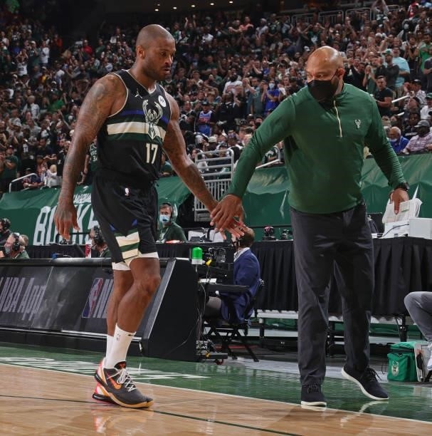 Tucker and Assistant Coach Darvin Ham of the Milwaukee Bucks high five during the game against the Brooklyn Nets during Round 2, Game 6 of the 2021...