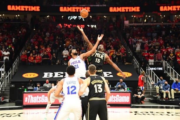 Joel Embiid of the Philadelphia 76ers and Clint Capela of the Atlanta Hawks jump for the ball during the opening tip-off during Round 2, Game 6 of...