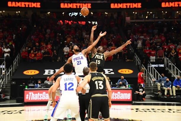 Joel Embiid of the Philadelphia 76ers and Clint Capela of the Atlanta Hawks jump for the ball during the opening tip-off during Round 2, Game 6 of...