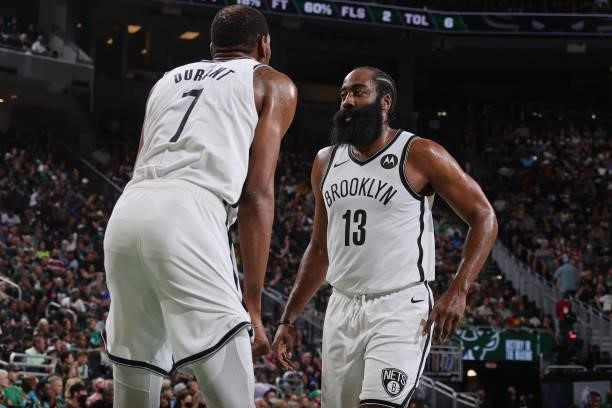 Kevin Durant and James Harden of the Brooklyn Nets talk in the game against the Milwaukee Bucks during Round 2, Game 6 of the 2021 NBA Playoffs on...