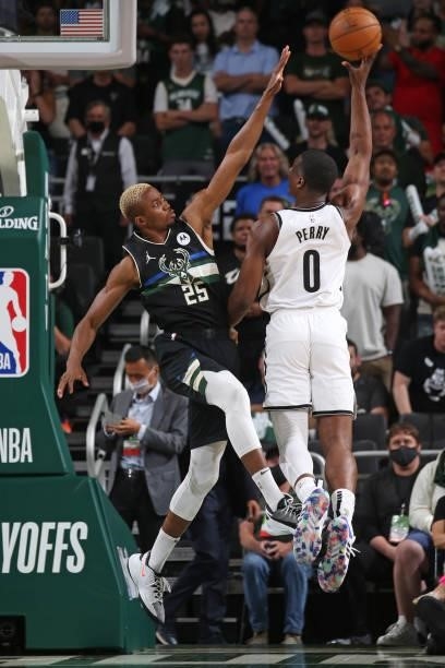 Reggie Perry of the Brooklyn Nets shoots the ball over Mamadi Diakite of the Milwaukee Bucks during Round 2, Game 6 of the 2021 NBA Playoffs on June...