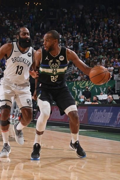 Khris Middleton of the Milwaukee Bucks handles the ball against James Harden of the Brooklyn Nets during Round 2, Game 6 of the 2021 NBA Playoffs on...