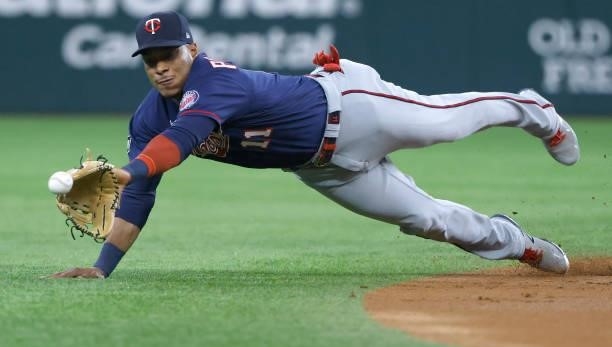 Jorge Polanco of the Minnesota Twins dives for a run scoring single off the bat of Nick Solak of the Texas Rangers during the first inning at Globe...