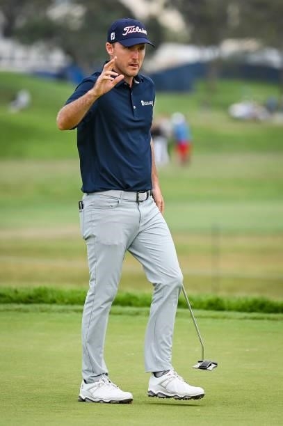 Russell Henley waves to fans after making a par putt on the sixth hole green during the second round of the 121st U.S. Open on the South Course at...