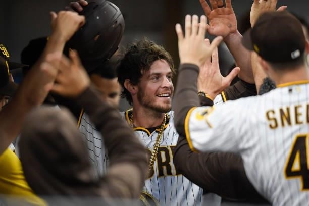 Wil Myers of the San Diego Padres is congratulatd in the dugout after hitting a solo home run during the second inning of a baseball game against the...