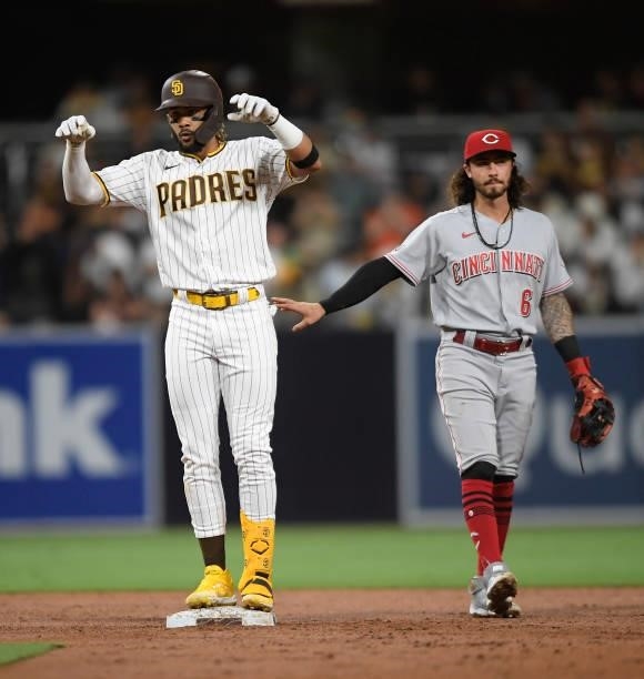 Fernando Tatis Jr. #23 of the San Diego Padres dances on second base after hitting a double as Jonathan India of the Cincinnati Reds looks on during...