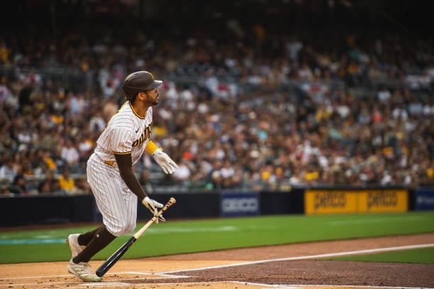 Tommy Pham of the San Diego Padres hits a home run in the first inning against the Cincinnati Reds on June 18, 2021 at Petco Park in San Diego,...