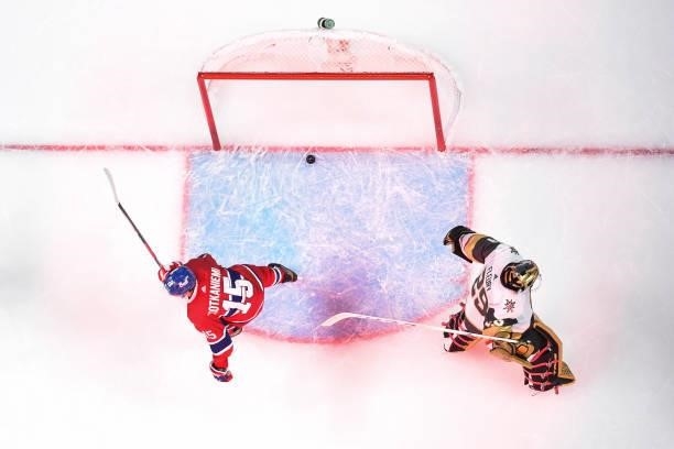 Jesperi Kotkaniemi of the Montreal Canadiens skates by an angered Marc-Andre Fleury of the Vegas Golden Knights as he swings his goal stick after...