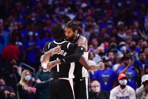 Paul George of the LA Clippers hugs Reggie Jackson of the LA Clippers during the game against the Utah Jazz during Round 2, Game 6 of the 2021 NBA...