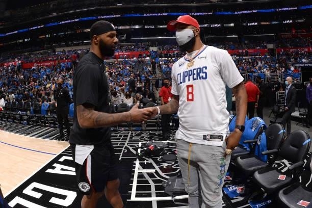 Marcus Morris Sr. #8 of the LA Clippers high-fives brother Markieff Morris of the Los Angeles Lakers after the game against the Utah Jazz during...