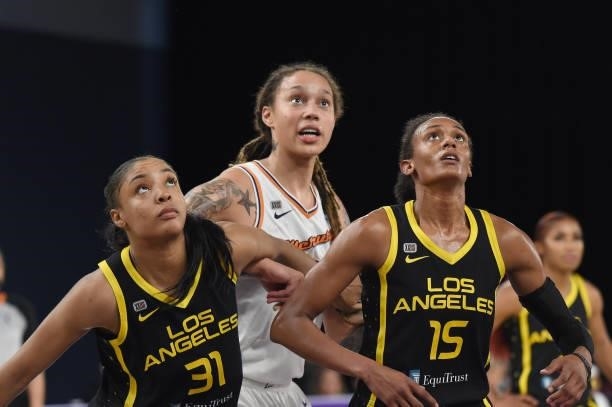 Kristine Anigwe and Brittney Sykes of the Los Angeles Sparks and Brittney Griner of the Phoenix Mercury look up during their game on June 18, 2021 at...